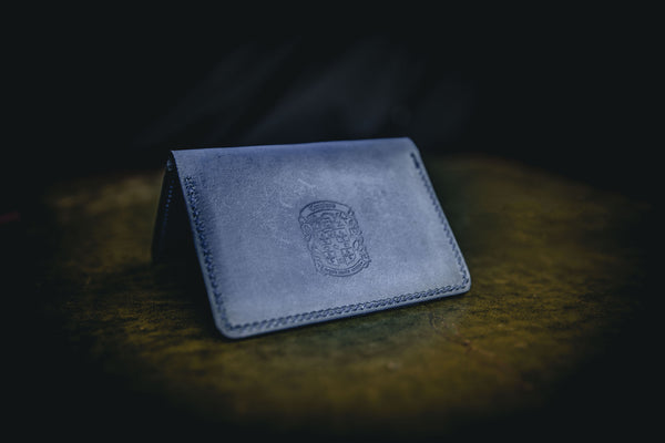 blue leather bi-fold business card wallet closed with coupland crest