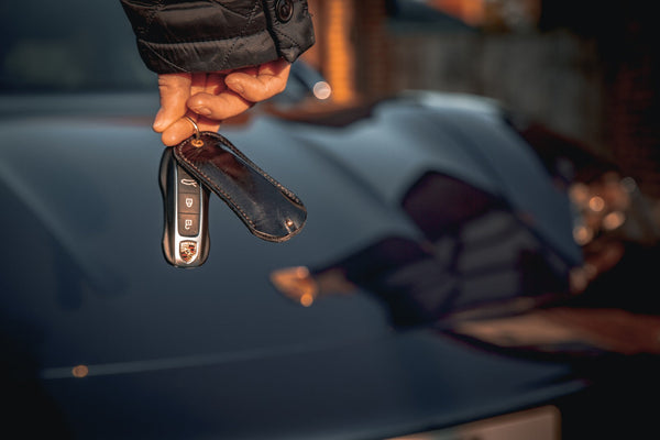 handmade leather Porsche tracker holder with keyring, crafted in North Yorkshire, luxury car accessory for Taycan, 911, Macan, and Panamera
