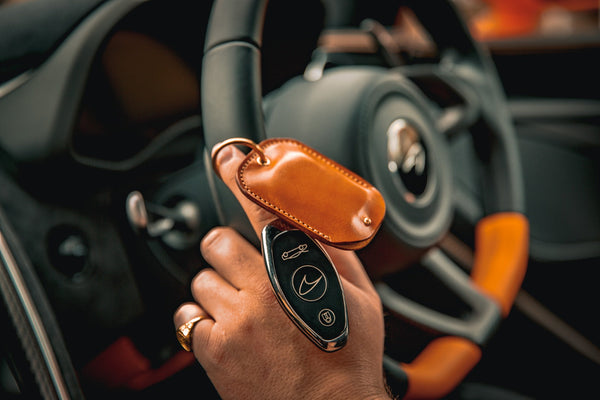 Bespoke leather tracker holders for Vodafone fobs, shown with brand-specific listings for Lamborghini, McLaren, Aston Martin, and Bentley.