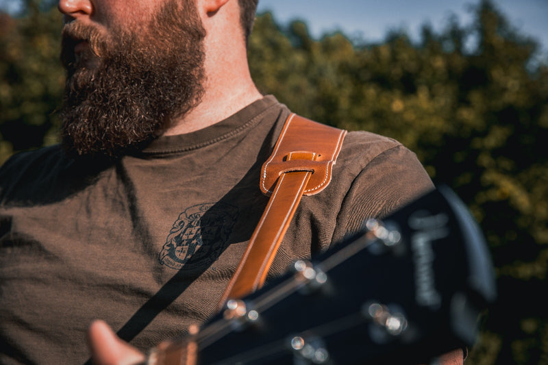 Leather acoustic guitar strap and headstock tie