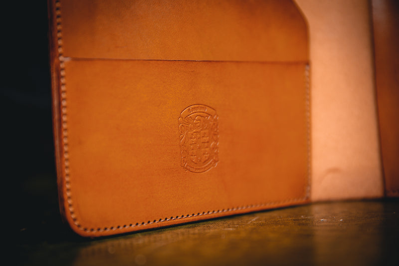 A5 tan leather book cover with coupland crest
