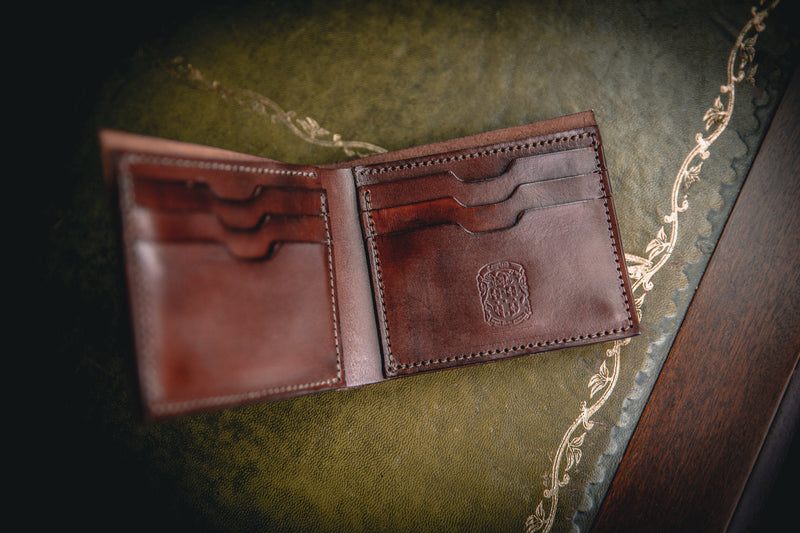 the AJ leather wallet in dark brown, open with coupland crest