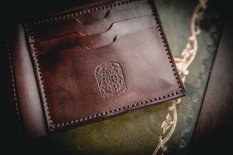 close up of AT leather wallet and coupland crest