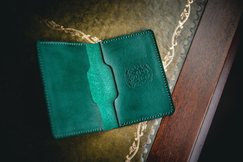 green leather bi-fold business card wallet open with coupland crest