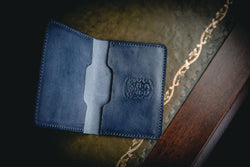 blue leather bi-fold business card wallet open with coupland crest