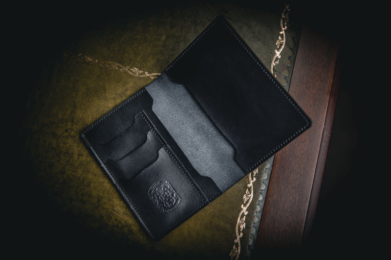 open black leather passport holder with coupland crest