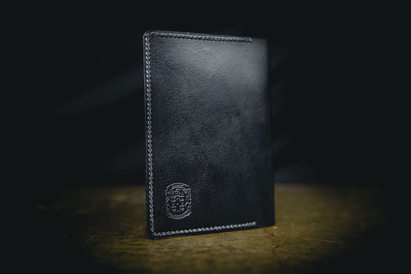 closed black leather passport holder with coupland crest