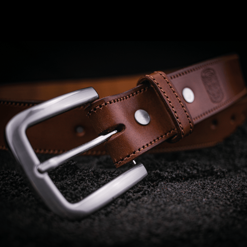 Silver buckle on bespoke leather belt