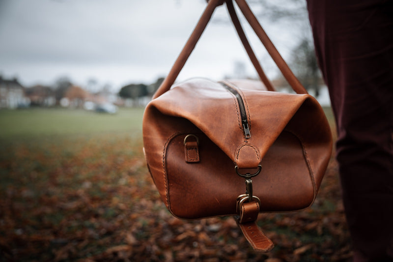side view of leather duffle bag