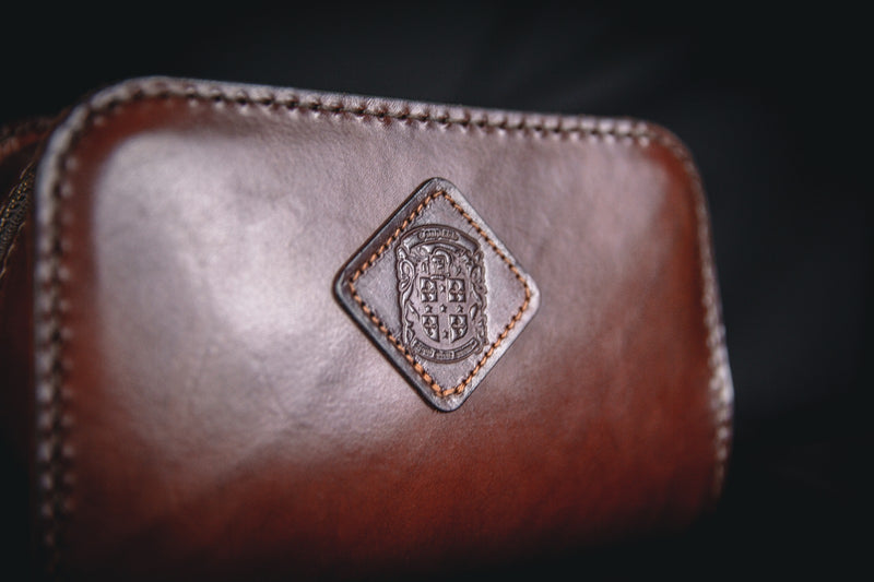 holmes leather toiletry bag with coupland crest close up
