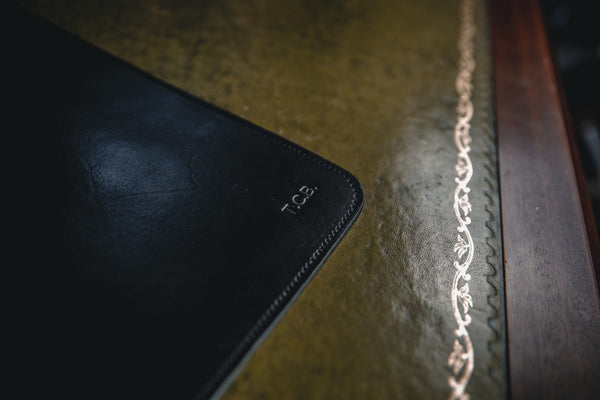 branded black leather desk mat