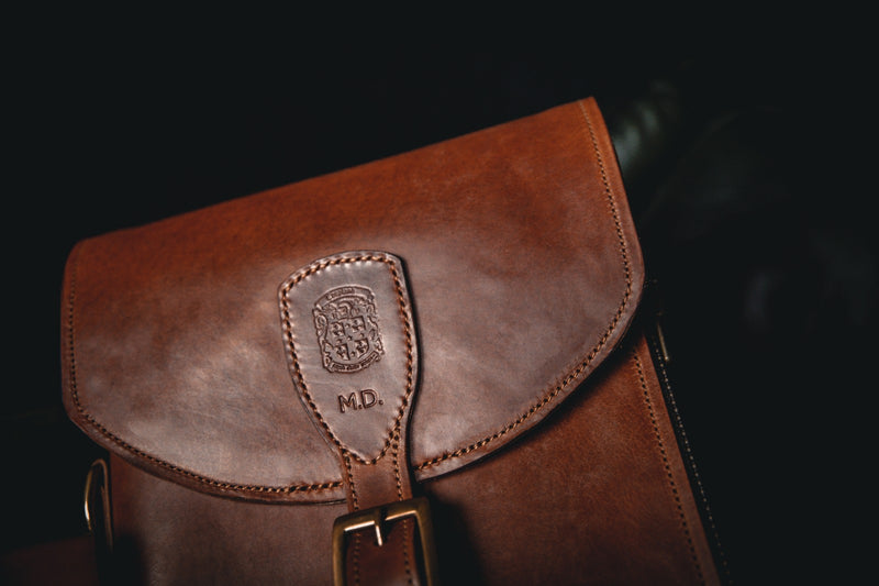 brown leather shotgun slip close up of coupland crest