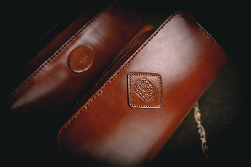 close up of coupland crest on large leather holmes toiletry bag